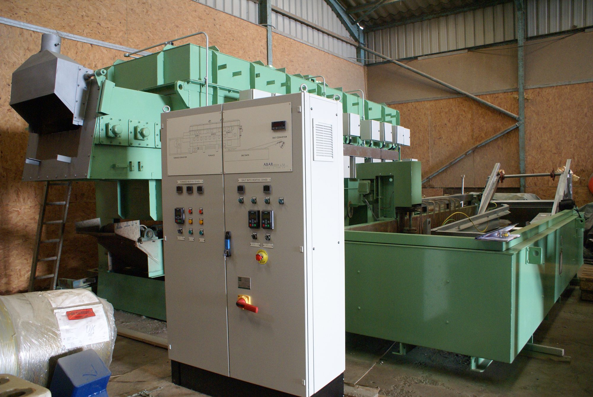 Large belt-fed austempering furnace with new electrical control cabinet