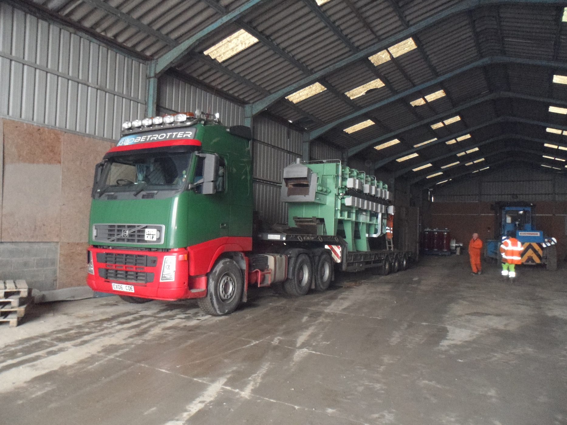 Large furnace being transported on a low-loader trailer