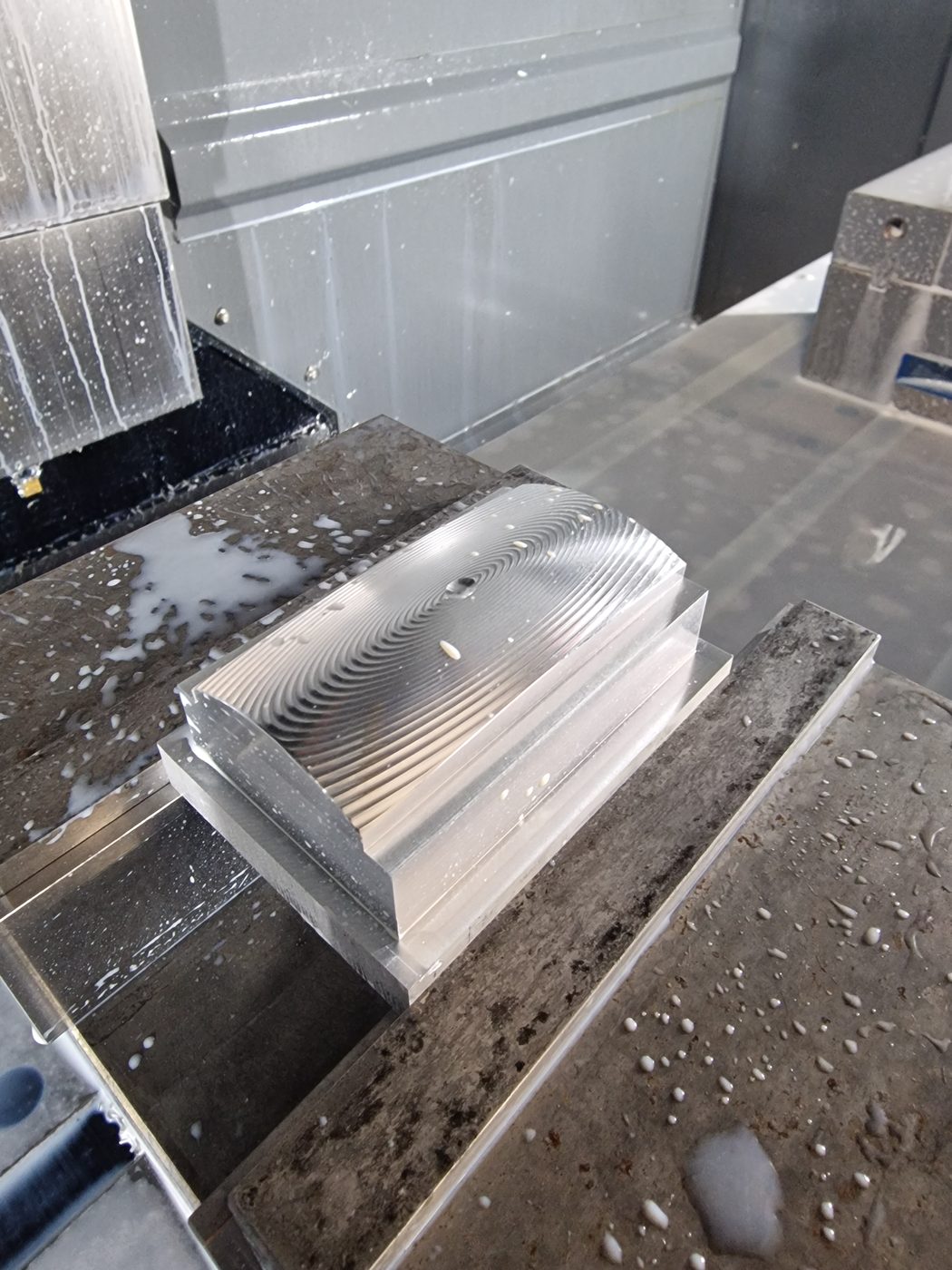 Close-up of a CNC milled aluminium component with fine ribbed machining detail